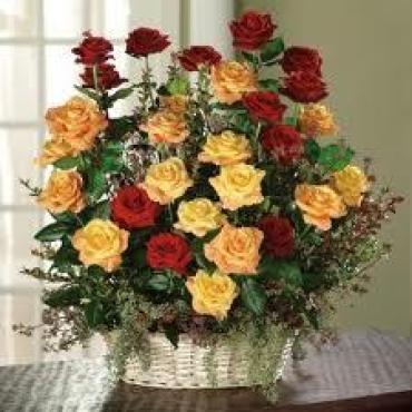 GARDEN BASKET OF RED ORANGE AND YELLOW ROSES